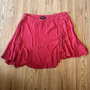 thin, flowy, red skirt with cinching on the front